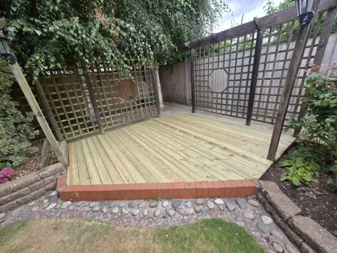 New timber decking installed in the same garden