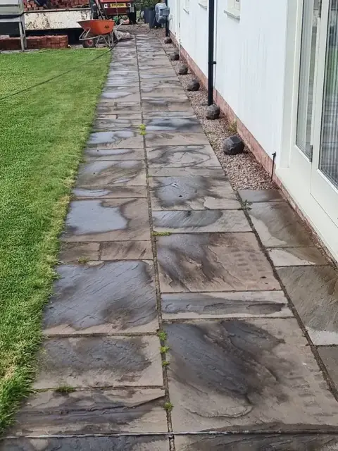Sandstone path covered in dirt and moss before pressure washing